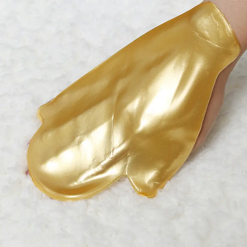 hand-mask-applied-on-white-background-softening-treatment 4K gold hand mask applied on hand for softening, anti-aging and spa-level repair care