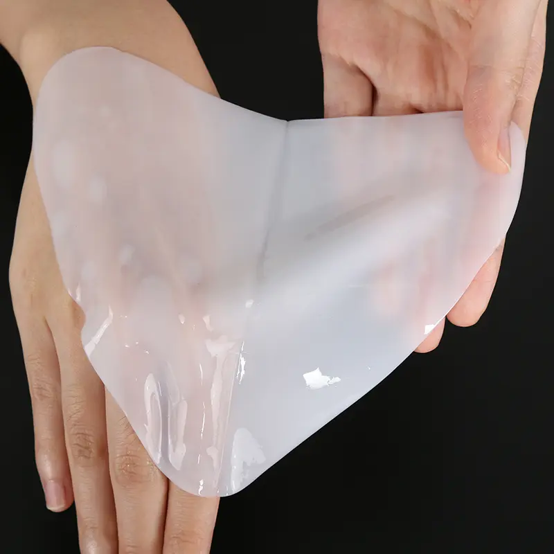 collagen-chest-mask-hand-holding-calla CALLA collagen chest mask hydrogel held by hand for private label OEM, light white skincare sheet